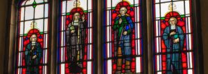 4 stained glass windows with saints