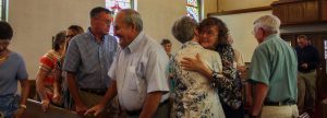 people hugging at church