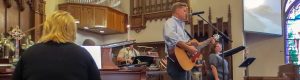 man playing guitar at church