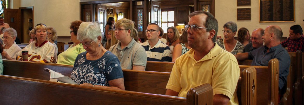 people sitting in pews at church